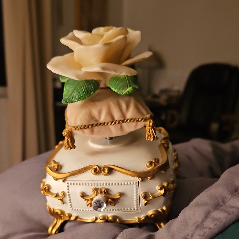 Avon Music Box Gold and Cream Decorative Box with Rose Accent On Pillow